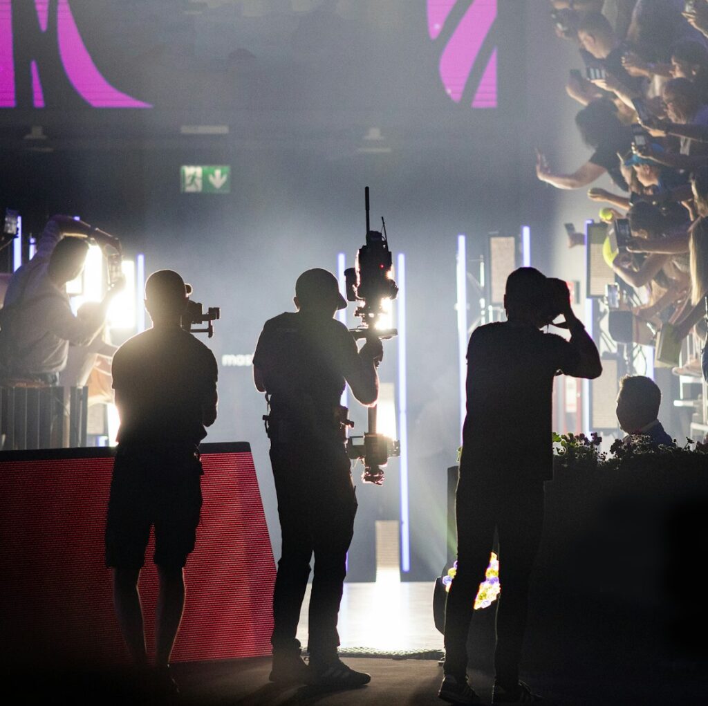 cameraman silhouette filming during event